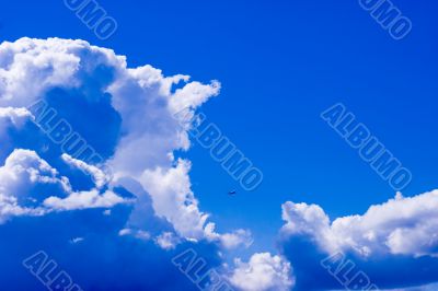 Tiny plane in vivid light cloudscape