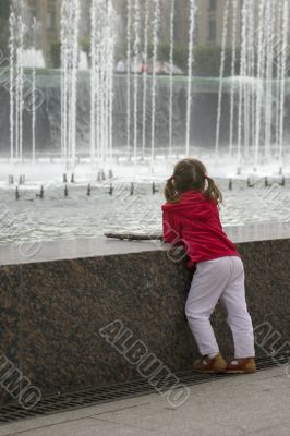 Thoughtful child near fountain