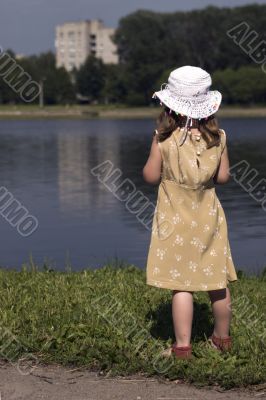 Little girl looking away on the back of a river