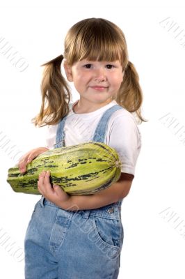 Little girl holding zucchini