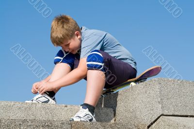 boy ties the shoe-lace