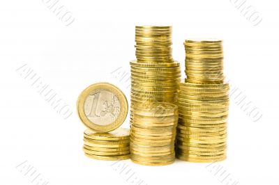 Stacks of coins with one euro on top