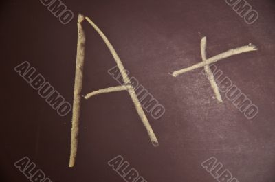 Chalkboard with an A plus written on it Chalkboard with an A plus written on it