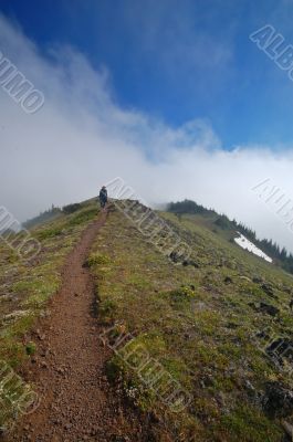 Man hiking on a trail in the mountains