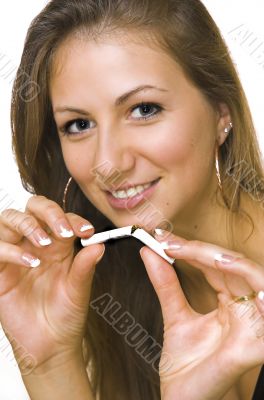 A smiling girl breaks a cigarette