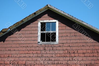 broken window on side of old barn