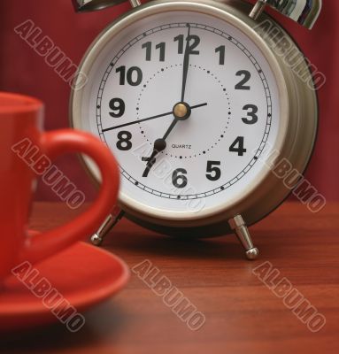 Coffee cup and alarm clock