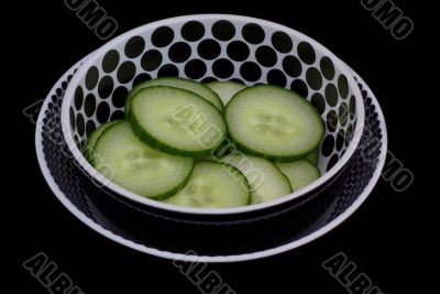 Sliced cucumber in bowl.
