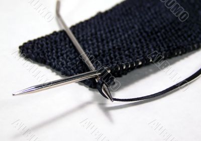 Knitting Black Ribbon With Silver Needles Knitting Black Ribbon With Silver Needles