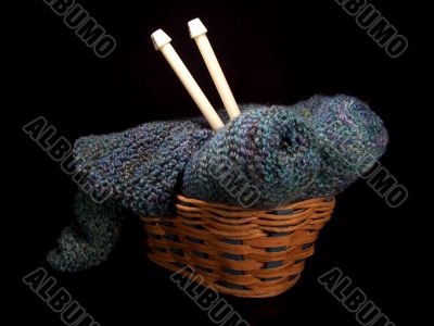 Knitting Supplies In A Basket With Needles
