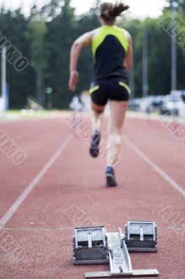 a woman is taking hurdles