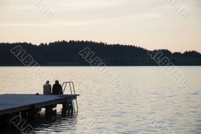 elderly couple by sunset