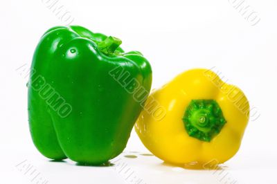 The isolated green and yellow peppers