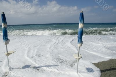 closed parasols with high water