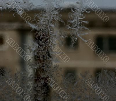 Closeup Ice Pattern on Window with Transparent Opposite House Fragment
