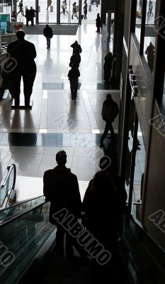 Silhouette Of Customers On Escalator