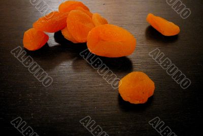 Dried apricots on black surface