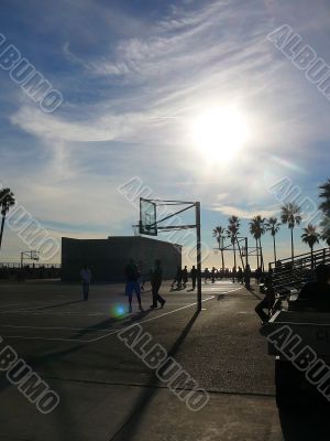 Beachside Basketball Game at Dusk