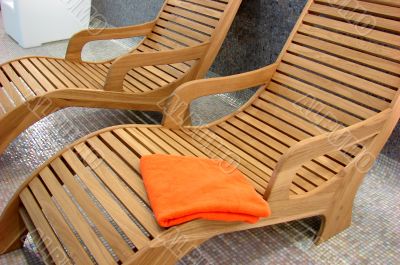 Sunbeds in the fitness with one orange towel