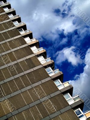 Tower block and cloudy blue sky