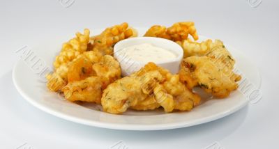 Battered pike perch with white sauce.