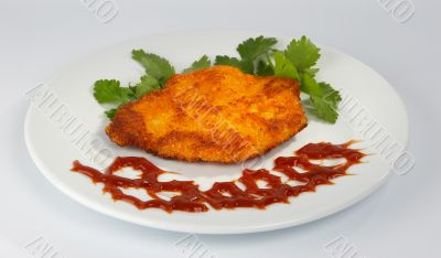 Rump steak with ketchup and greens.