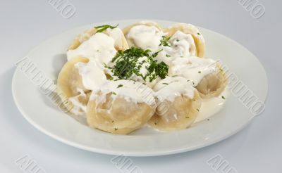 Dumplings with sour cream and greens.