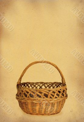wicker basket against stained retro paper
