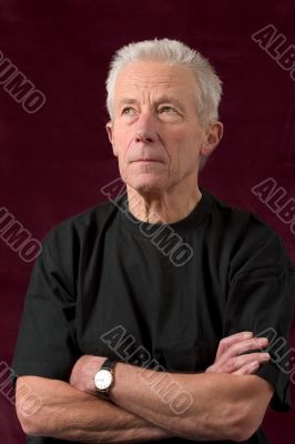Serious looking older man casually dressed Serious looking older man casually dressed