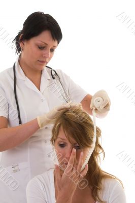 Nurse bandaging a patient