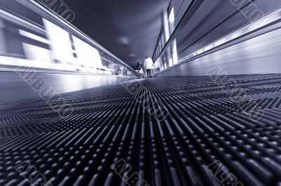 traveling on a moving escalator
