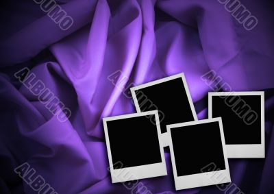 four photo frames against textile background