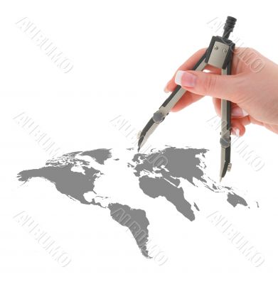 hand with compasses on world map