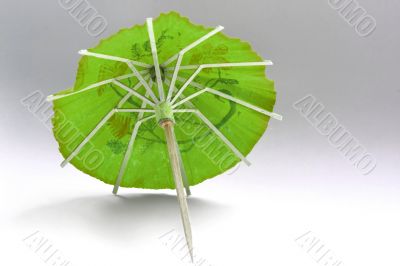 close-up of green cocktail umbrella