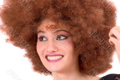 Teenager having fun with curly wig