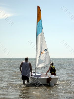 father and son with sailboat