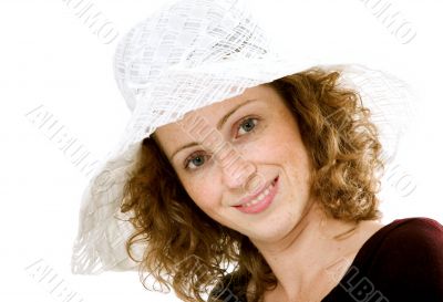 Portrait of red-haired model in a white hat.