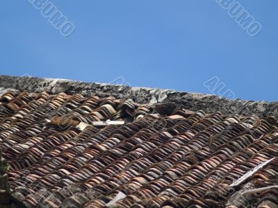 Roof tiles of an old, damaged villa