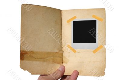 aged open book  with polaroid frame