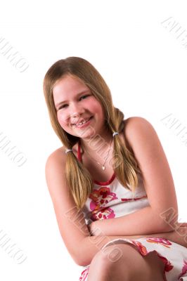 Pretty blond ten year old sitting and laughing