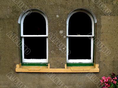  Two arched windows in textured stonework