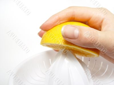 juicer with hand and half of orange juicer with hand and half of orange