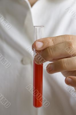 laboratory assistant with test tubes in hand