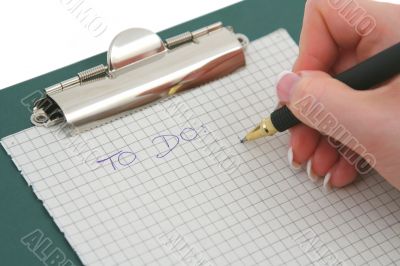 female hand writing TO DO list