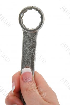 female hand holding wrench tool