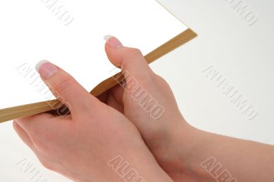 hands holding hollow book