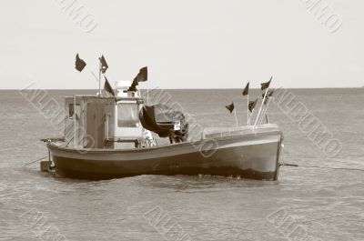 old fisging boat - sepia tone