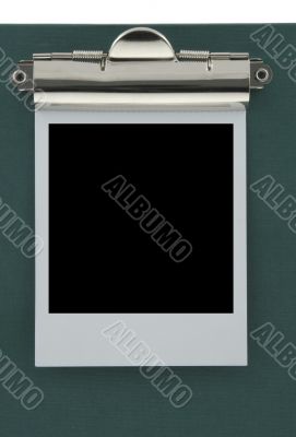empty photo frame stuck to a clipboard