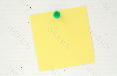 post it pinned to a cardboard background