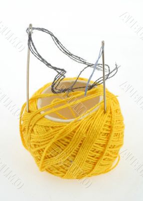 yellow thread and needles on white